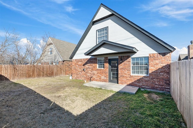 rear view of property with a patio and a yard