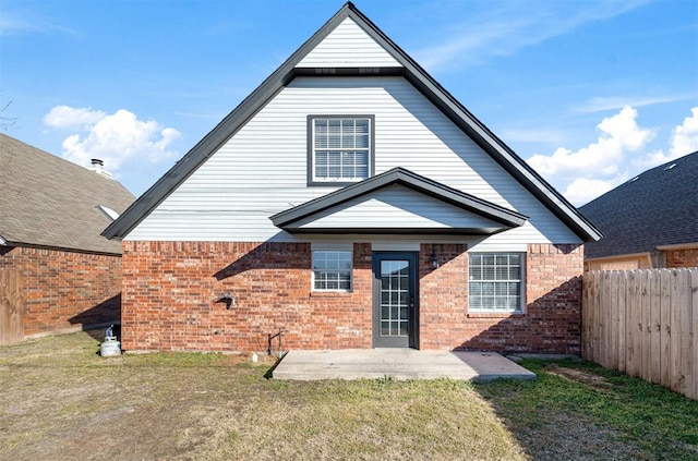 back of property featuring a yard and a patio