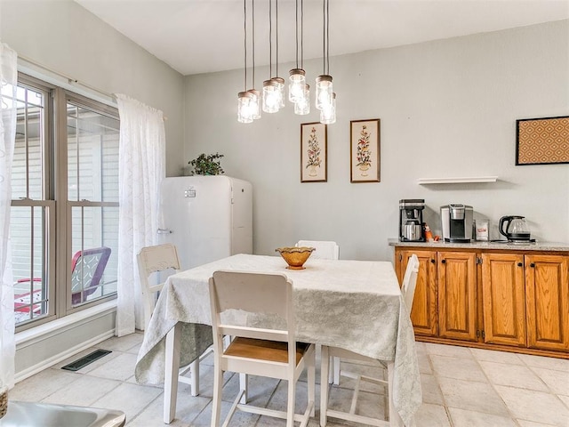 dining space featuring light tile patterned floors