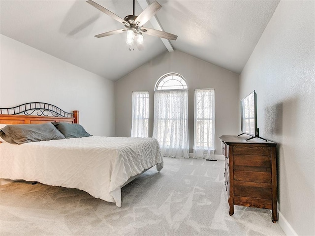 bedroom featuring light carpet, ceiling fan, lofted ceiling with beams, and baseboards
