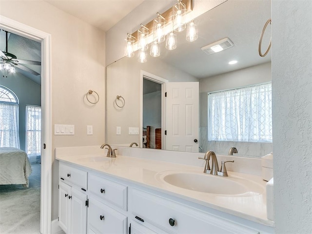 ensuite bathroom with a sink, visible vents, ceiling fan, and connected bathroom