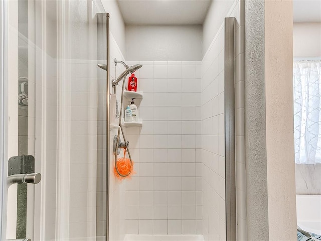 full bath featuring a stall shower and a healthy amount of sunlight