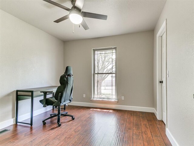 office with visible vents, baseboards, a ceiling fan, and hardwood / wood-style floors