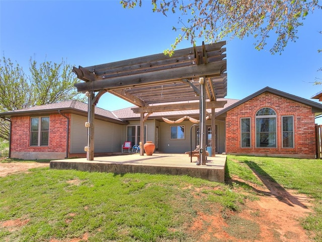 back of property featuring a patio area, brick siding, a lawn, and a pergola