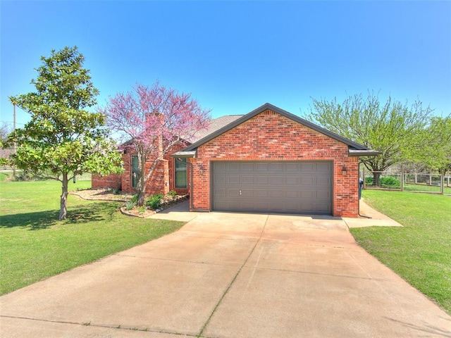traditional-style home featuring concrete driveway, a front yard, a garage, and brick siding