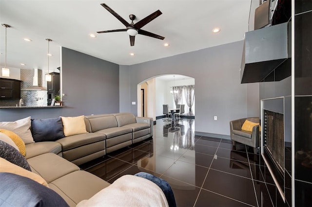 tiled living room featuring ceiling fan