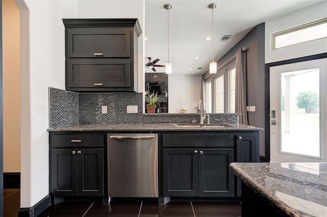 kitchen featuring sink, tasteful backsplash, stainless steel dishwasher, pendant lighting, and dark stone counters