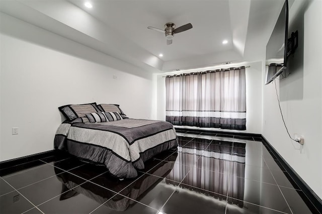 bedroom featuring a tray ceiling and ceiling fan