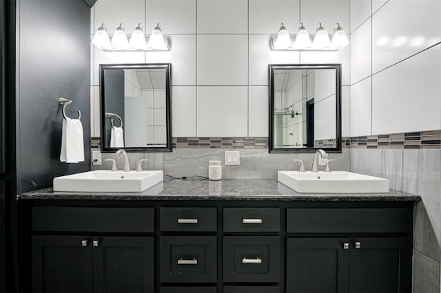 bathroom with tasteful backsplash and vanity