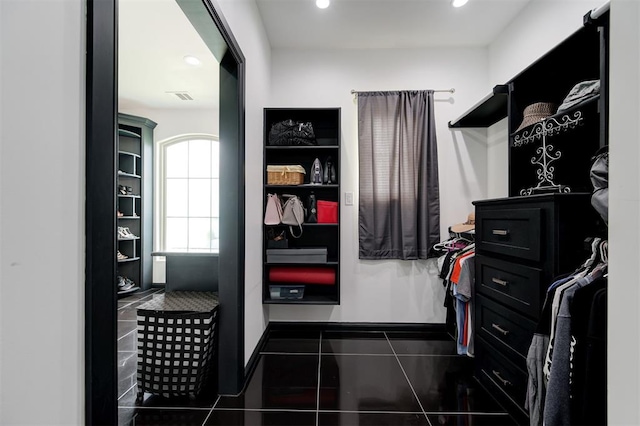 walk in closet with dark tile patterned floors