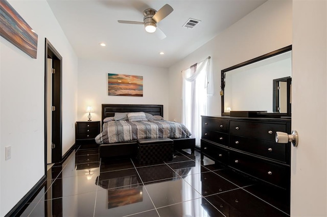 bedroom with ceiling fan and dark tile patterned flooring