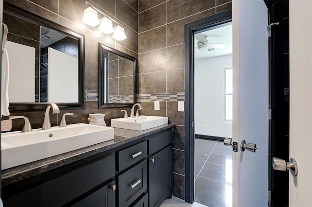 bathroom with vanity, backsplash, tile patterned flooring, and tile walls