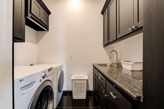 laundry area featuring sink, washing machine and dryer, and cabinets