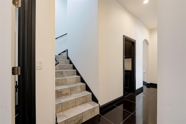 stairs featuring tile patterned floors