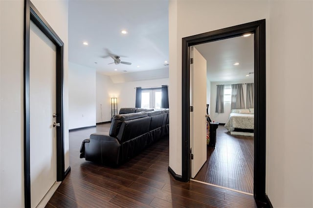 corridor with dark hardwood / wood-style flooring