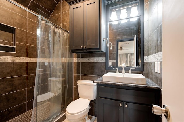 bathroom featuring toilet, a shower with curtain, tasteful backsplash, tile walls, and vanity