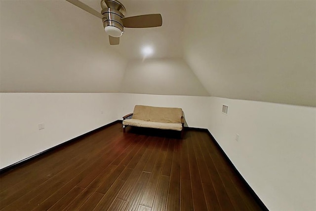 unfurnished bedroom featuring dark hardwood / wood-style flooring, lofted ceiling, and ceiling fan