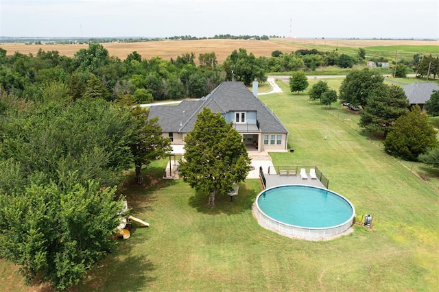 view of swimming pool featuring a rural view