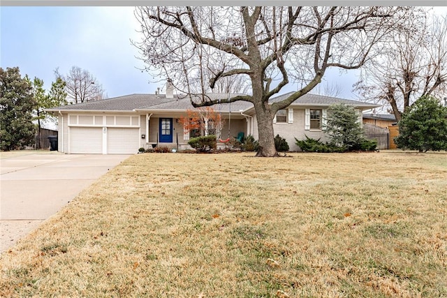 ranch-style home featuring a garage and a front yard