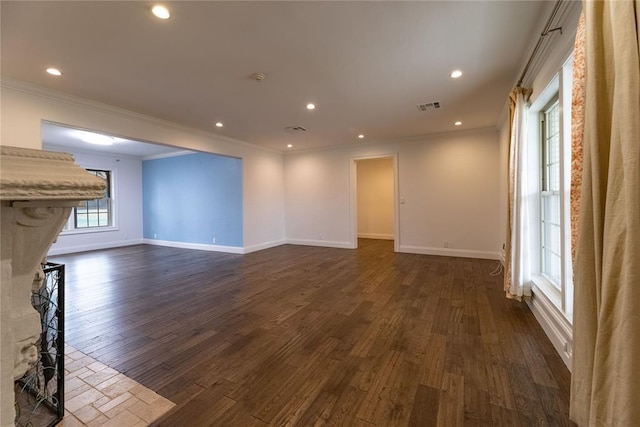 unfurnished living room with ornamental molding and dark hardwood / wood-style floors