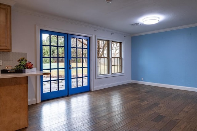 interior space featuring ornamental molding, dark hardwood / wood-style flooring, and french doors