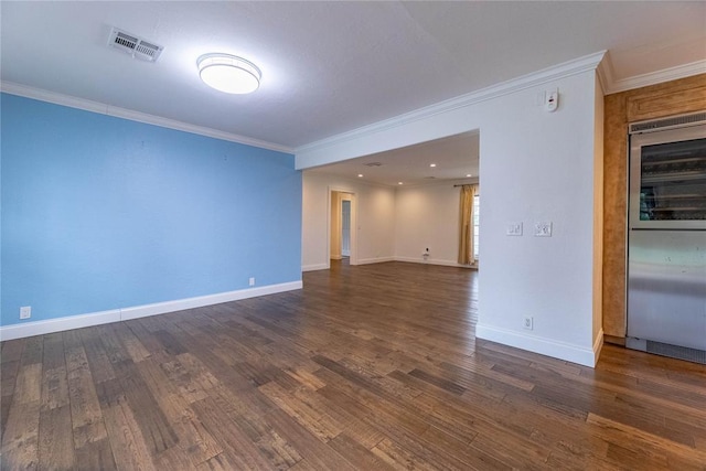 empty room with crown molding and dark wood-type flooring