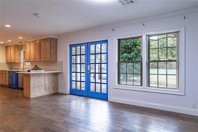 kitchen featuring ornamental molding, plenty of natural light, dark hardwood / wood-style floors, and french doors