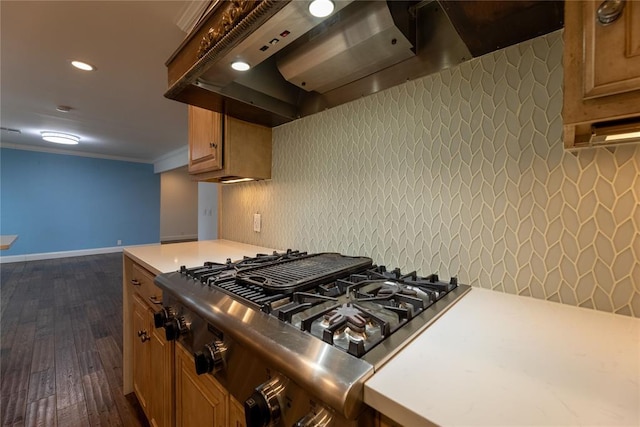 kitchen with wall chimney exhaust hood, stainless steel gas cooktop, tasteful backsplash, ornamental molding, and dark hardwood / wood-style floors