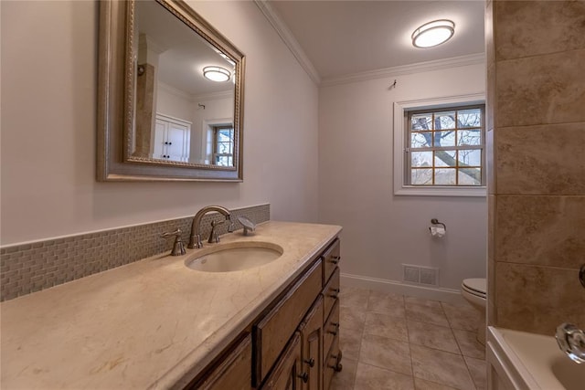 bathroom with tile patterned floors, toilet, ornamental molding, vanity, and a washtub