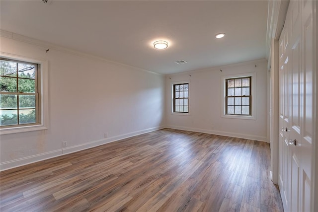 spare room featuring ornamental molding and wood-type flooring