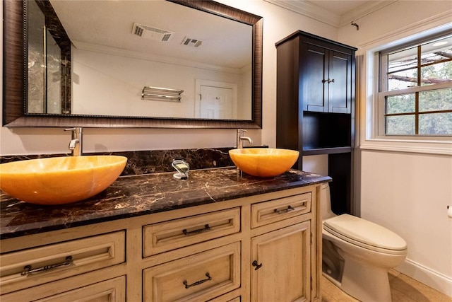 bathroom featuring ornamental molding, vanity, and toilet