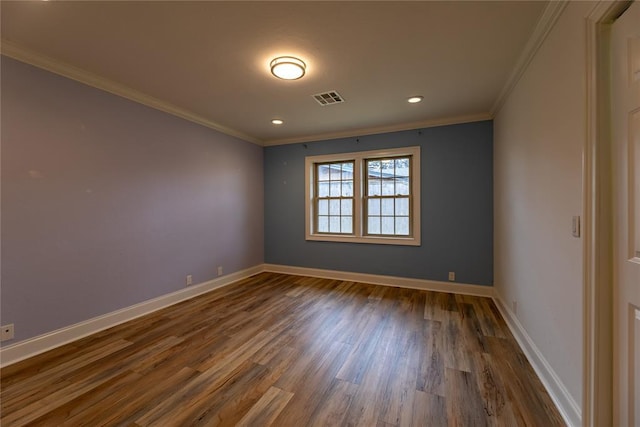 spare room featuring crown molding and dark hardwood / wood-style flooring