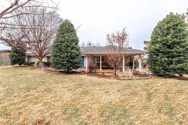 rear view of property featuring a yard