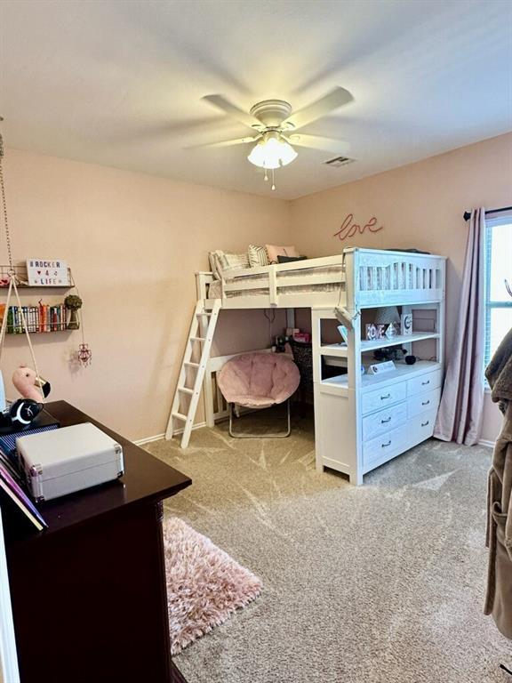 carpeted bedroom with ceiling fan