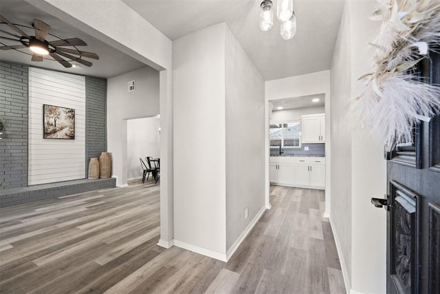 corridor with light hardwood / wood-style flooring