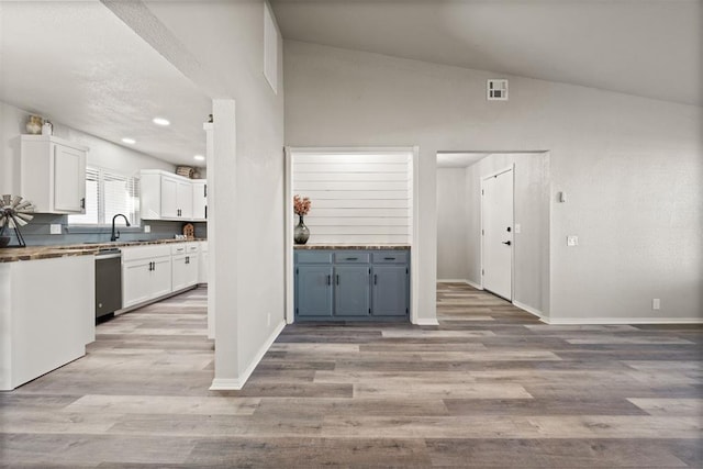 kitchen featuring white cabinetry, sink, light hardwood / wood-style flooring, and stainless steel dishwasher