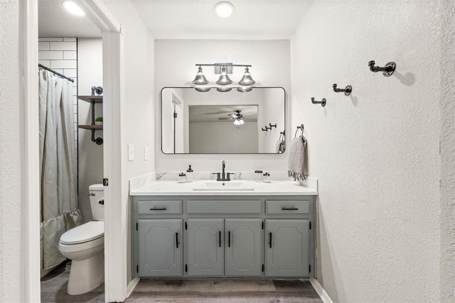 bathroom featuring vanity, wood-type flooring, toilet, and a shower with shower curtain