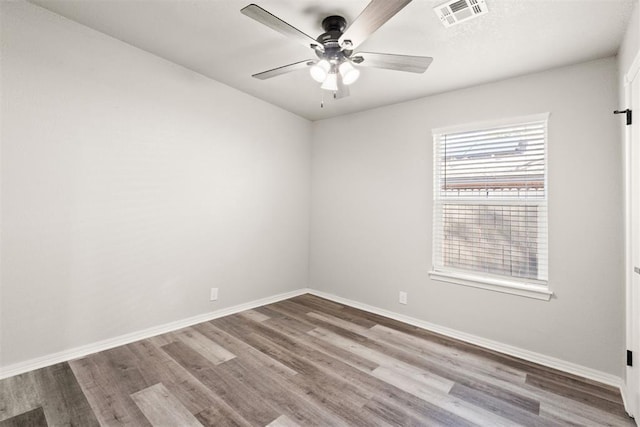 spare room featuring hardwood / wood-style flooring and ceiling fan