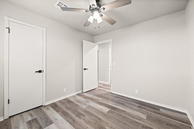 unfurnished bedroom with ceiling fan and light hardwood / wood-style flooring