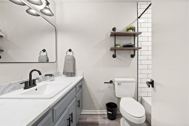 full bathroom featuring vanity, hardwood / wood-style flooring, toilet, and shower / bath combination