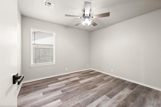 empty room with hardwood / wood-style floors and ceiling fan