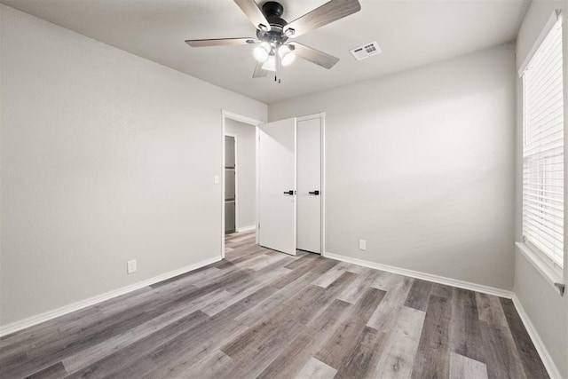 empty room featuring ceiling fan and light wood-type flooring