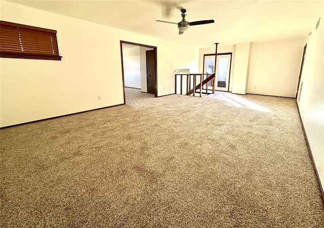 empty room featuring carpet floors and ceiling fan