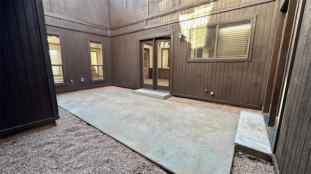 empty room with carpet floors and wooden walls