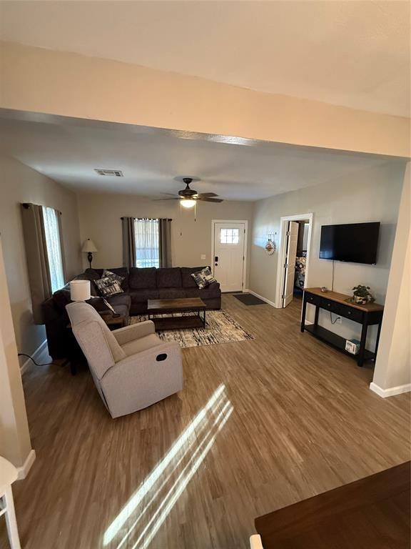 living room with hardwood / wood-style floors and ceiling fan