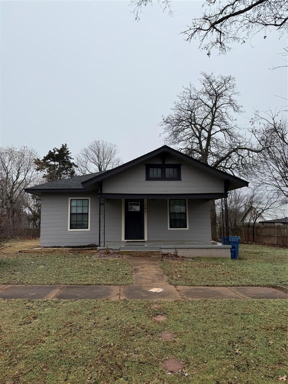 view of front of property with a porch and a front lawn