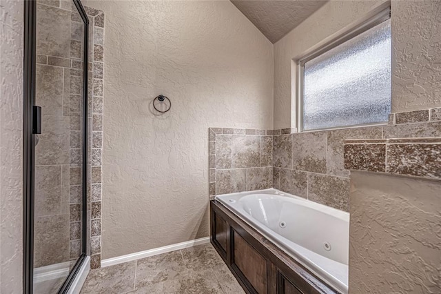 bathroom featuring lofted ceiling, separate shower and tub, and a textured ceiling