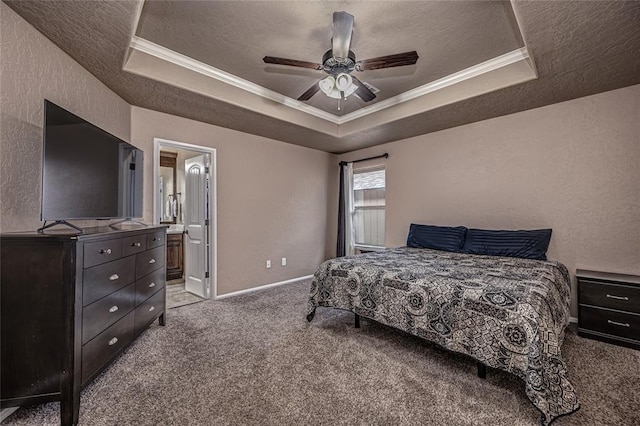 carpeted bedroom featuring crown molding, ensuite bath, a textured ceiling, a raised ceiling, and ceiling fan