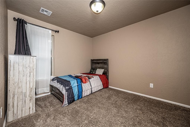 bedroom featuring carpet floors and a textured ceiling