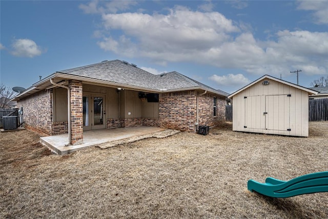 rear view of house with a storage shed, a playground, a patio area, and central air condition unit